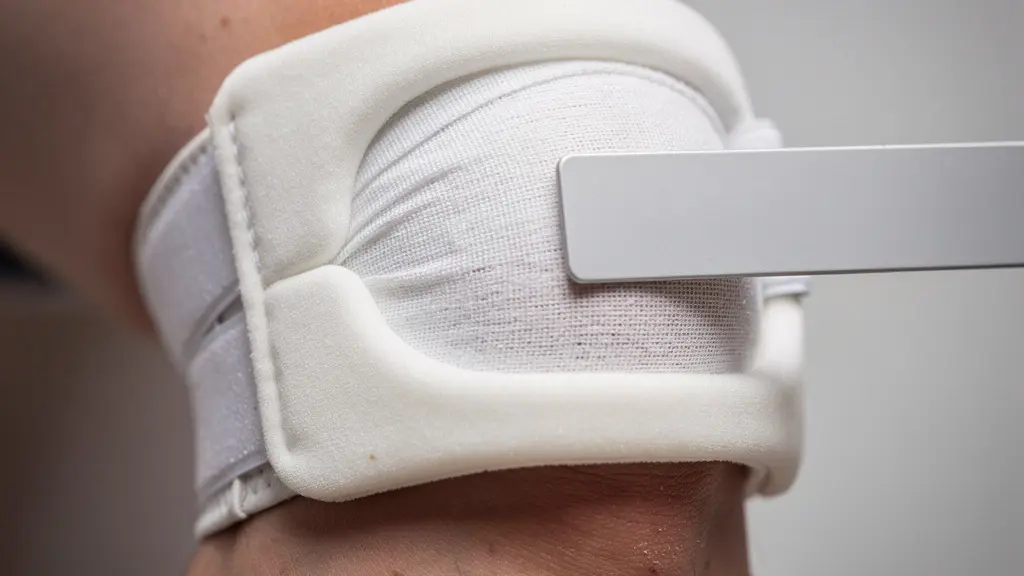 Macro d’un genou bandé et d’un instrument de mesure médical non marqué, évoquant l’évaluation d’un taux d’invalidité après accident.